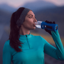 Recover from exercise with U Perform Active Collagen - lady drinking water from a bottle after exercise