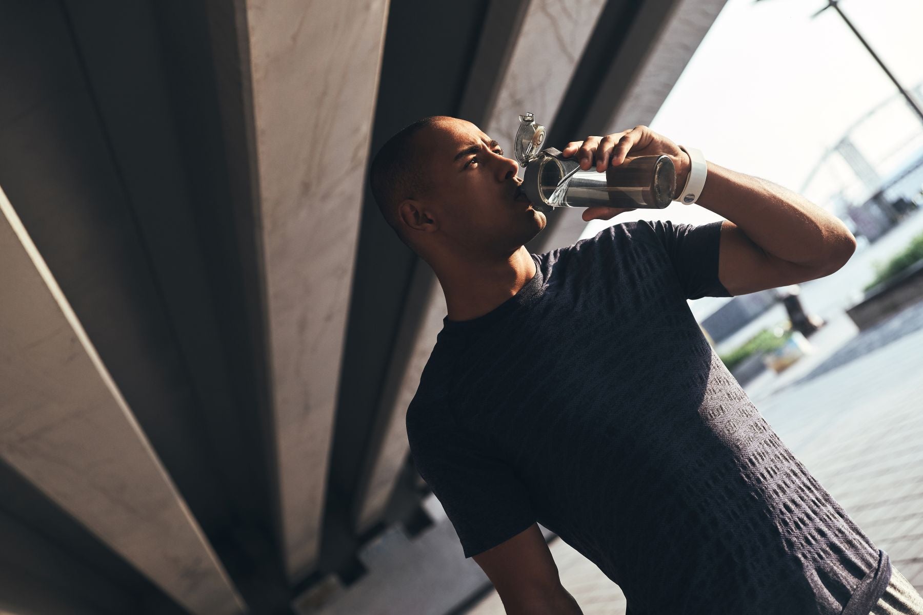 Man drinking from sports bottle 